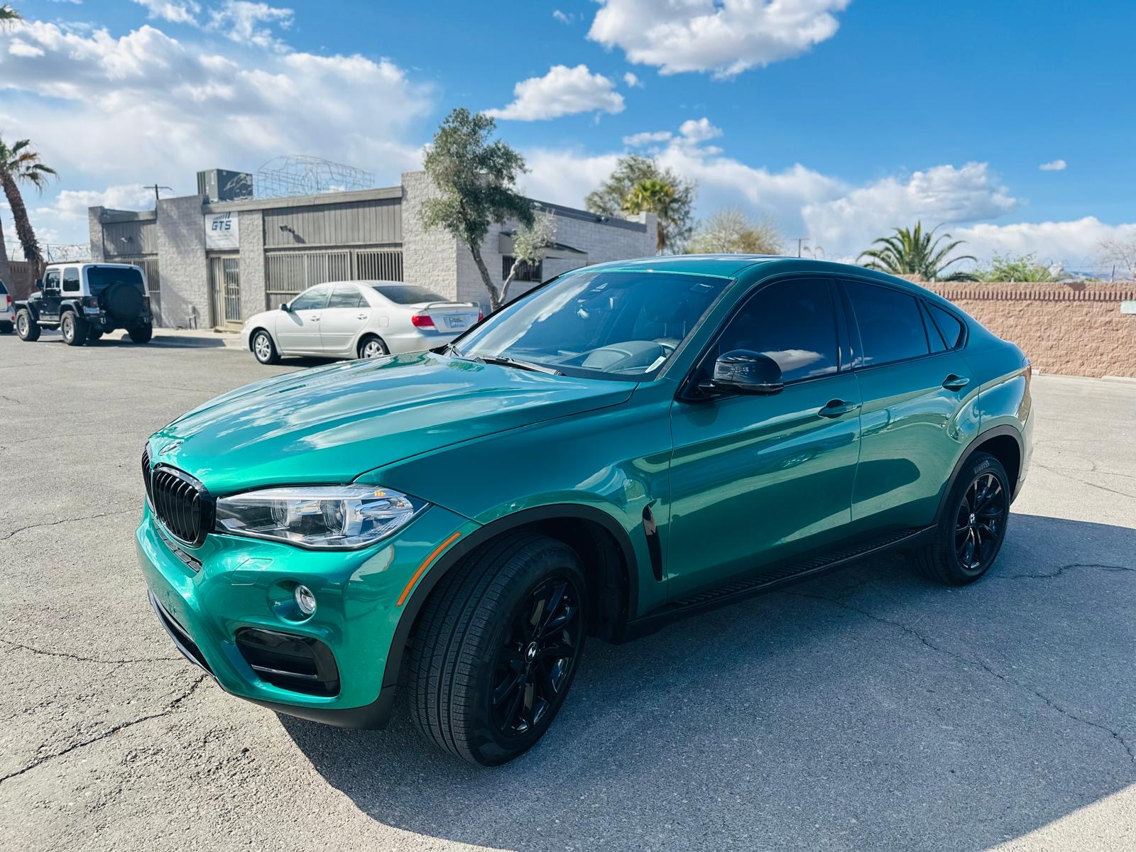 BMW X6 after custom paint - stunning teal metallic finish